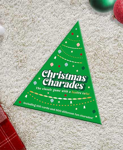 Green 'Christmas Charades' game box with festive design on a carpeted floor.