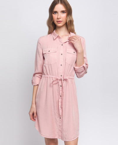 Pink denim dress with pockets on the chest area and a drawstring on the waistline. Dress length is above the knee.