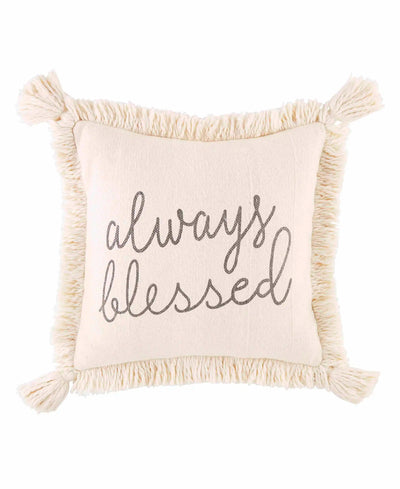 Cream fringe pillow that reads, "Always Blessed." Writing is in the color black