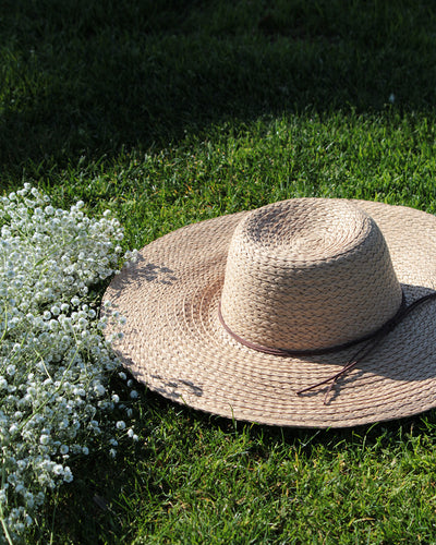 Brown straw hat with brown tie